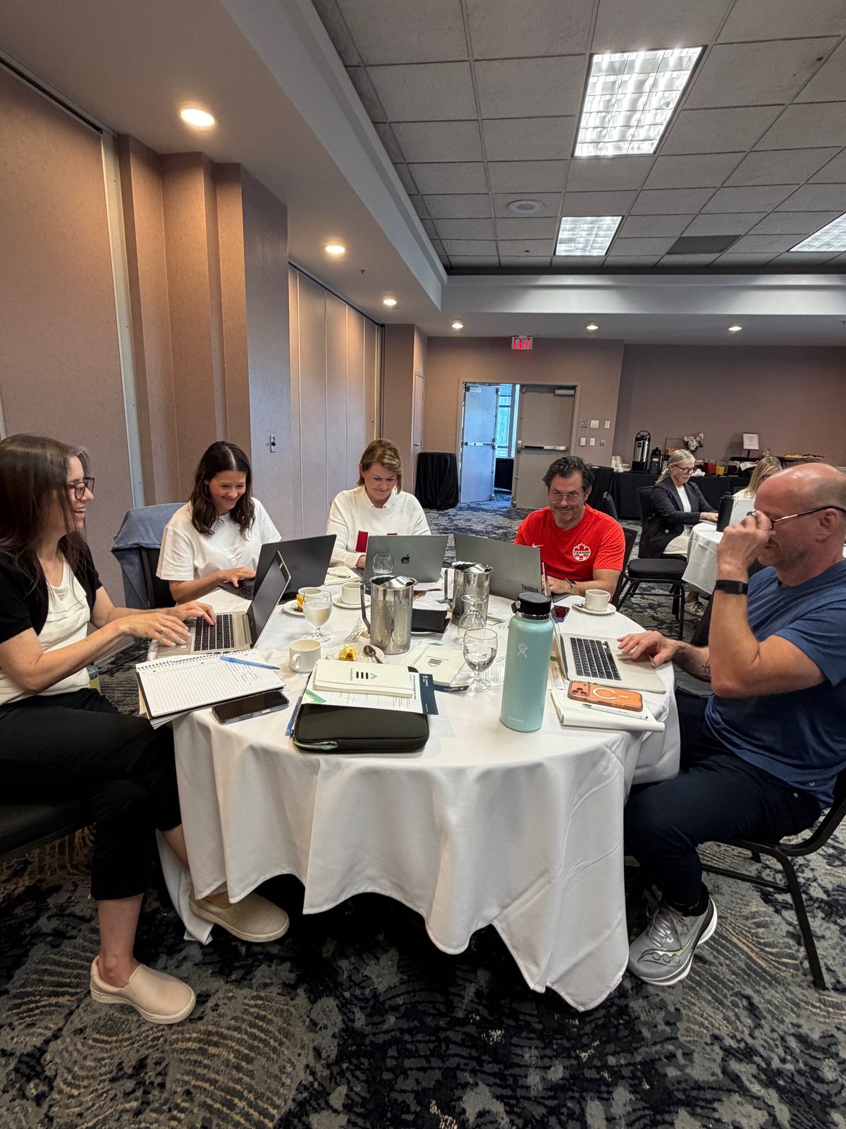 Brokers working together at a table during the workshop